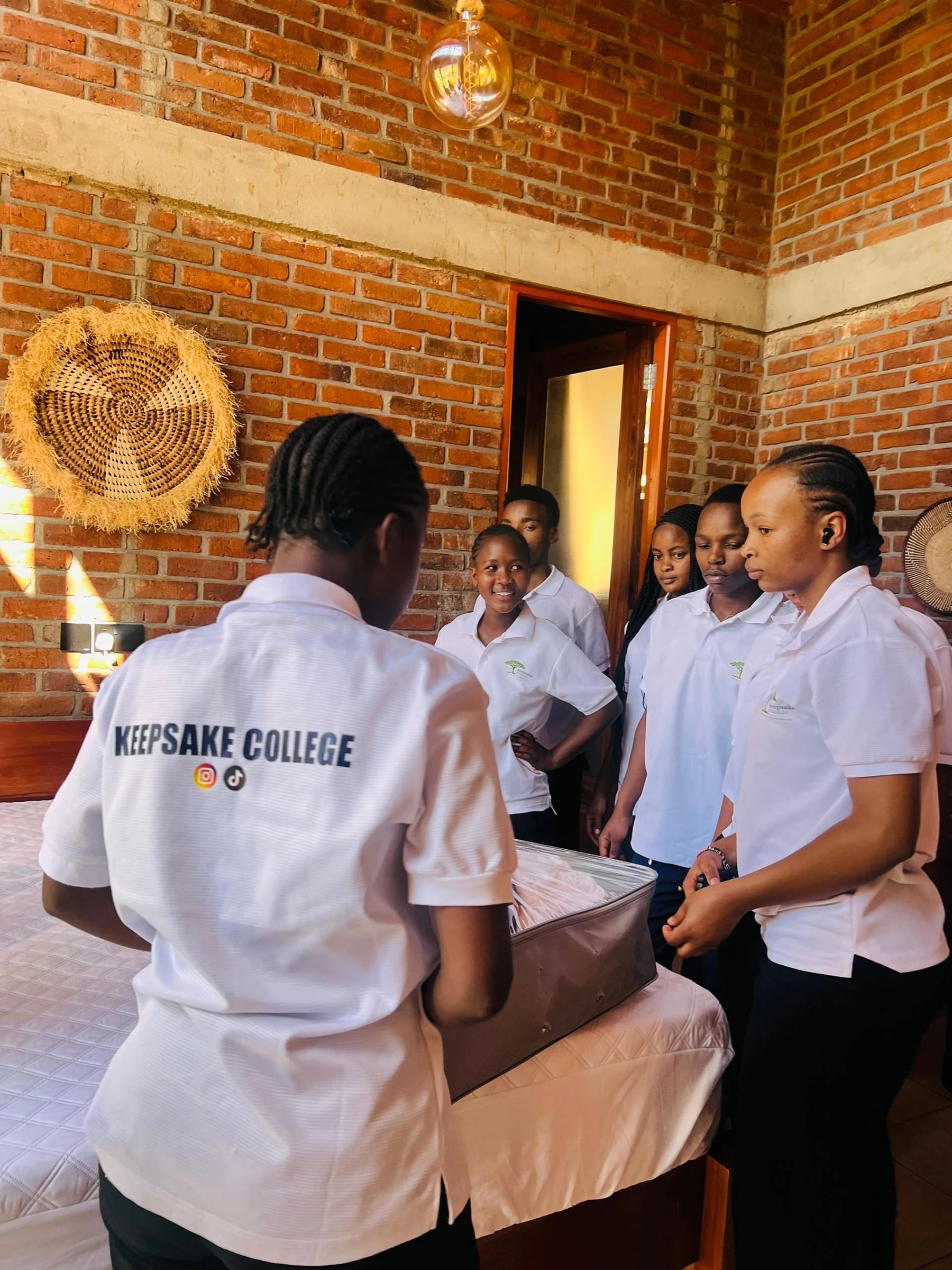 Keepsake students gathered around a bed during training