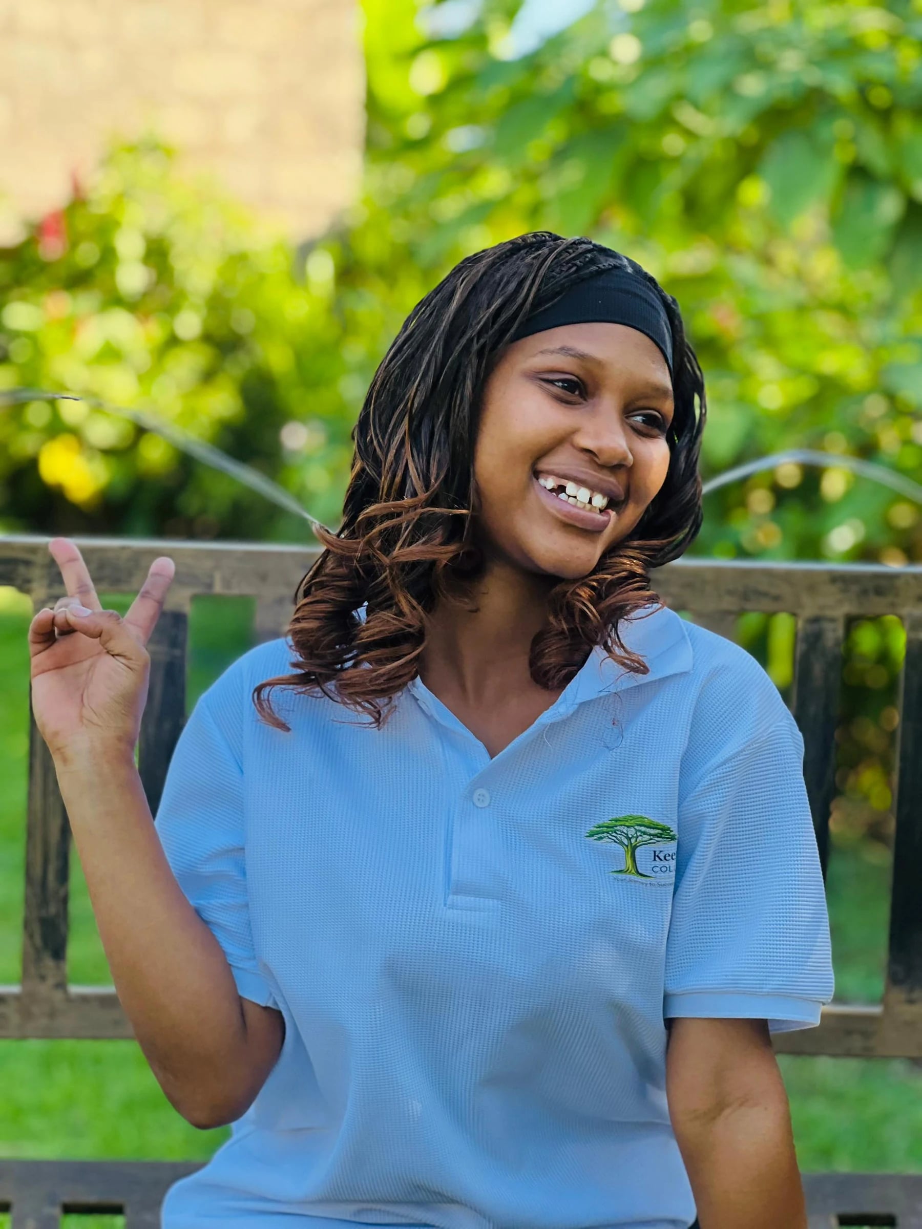 A Keepsake student smiling and gesturing outdoors