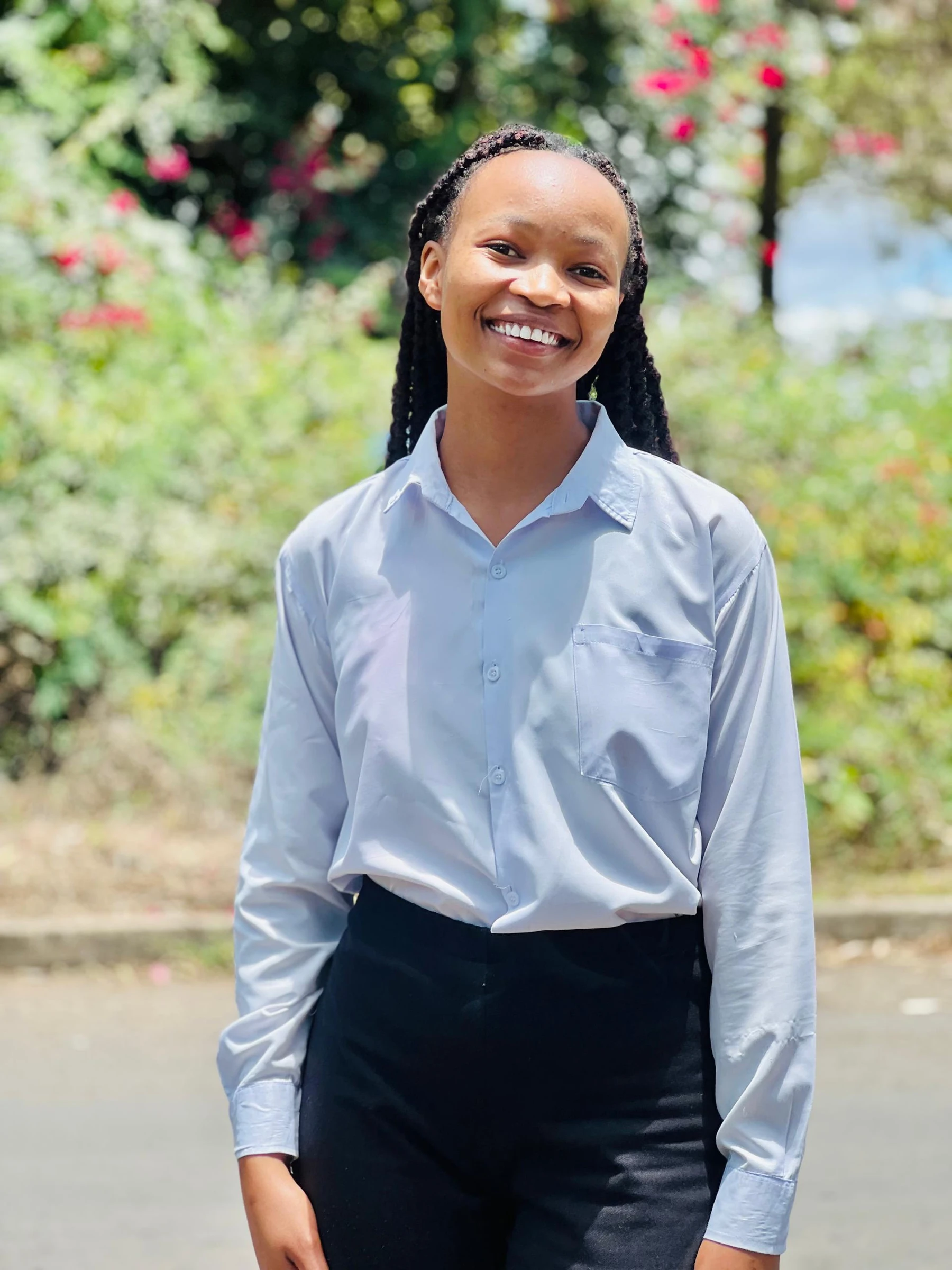 A smiling Keepsake student standing in a garden