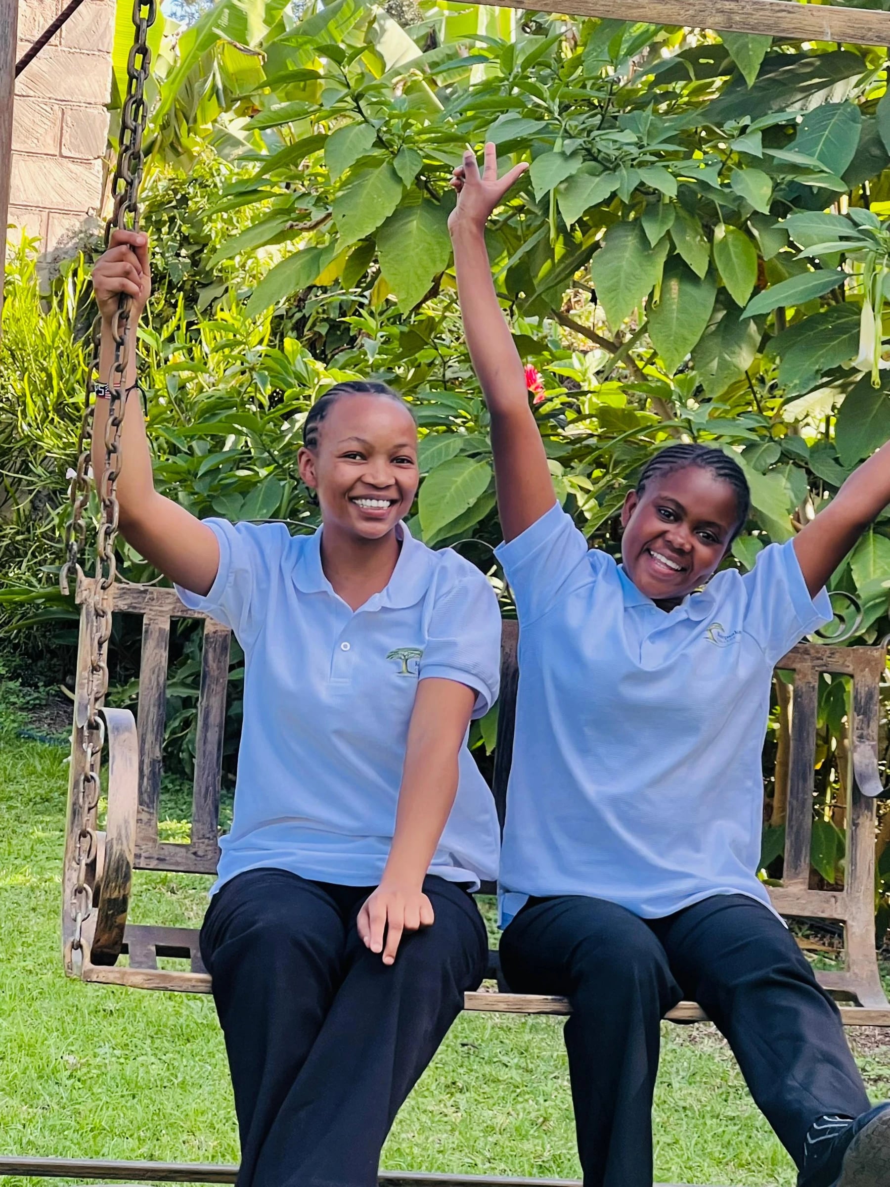 Two Keepsake students smiling together beneath a tree