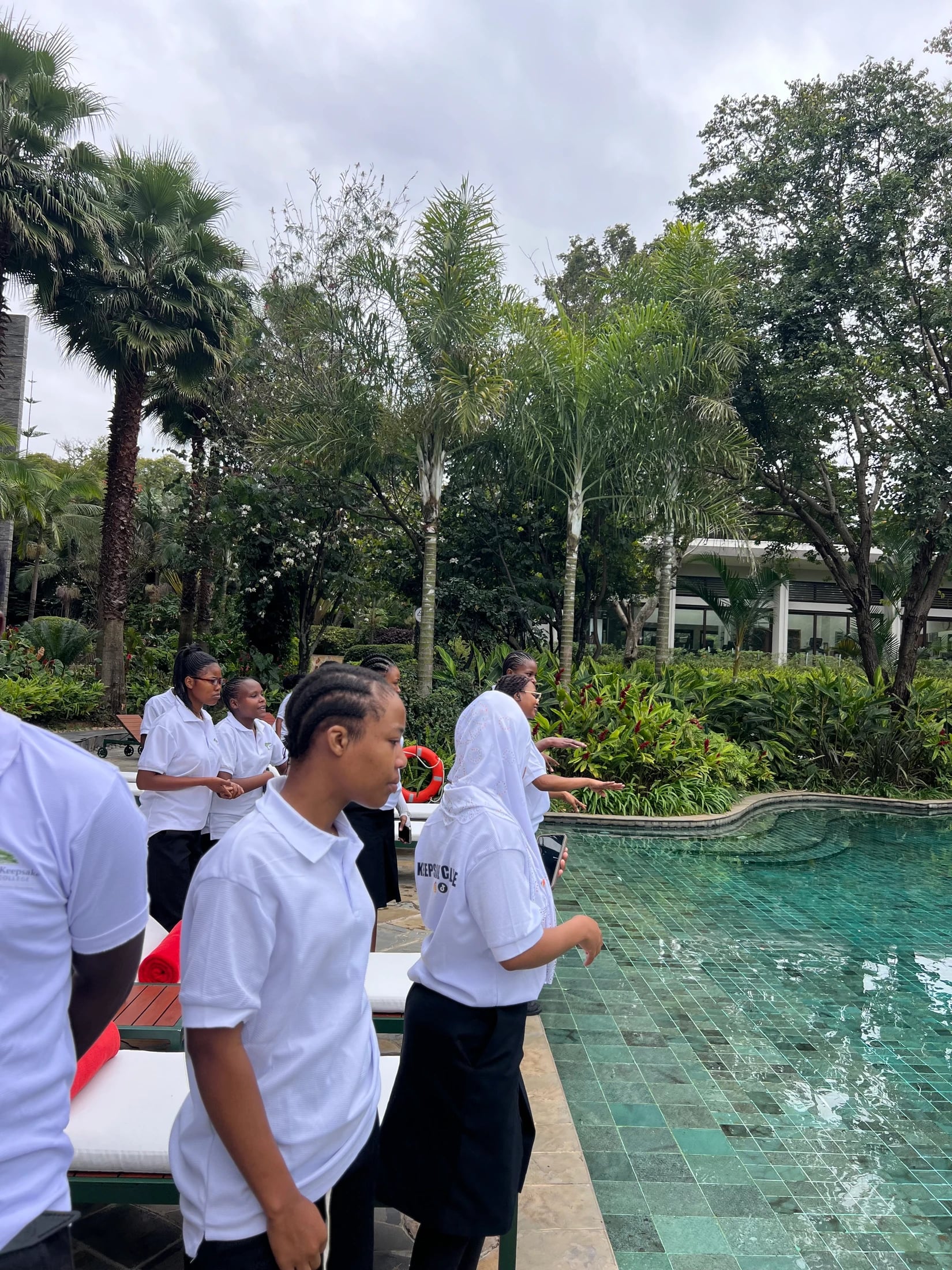 Keepsake students standing together beside a swimming pool