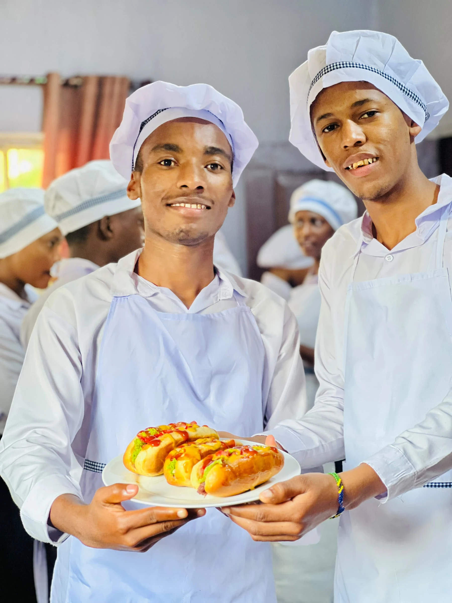Two Keepsake culinary students presenting a prepared dish