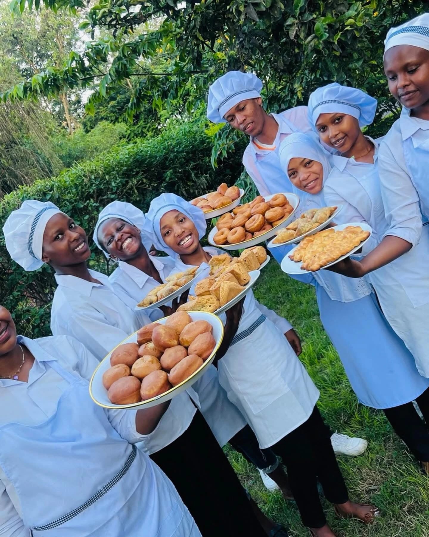 Keepsake culinary students presenting different prepared foods together outdoors