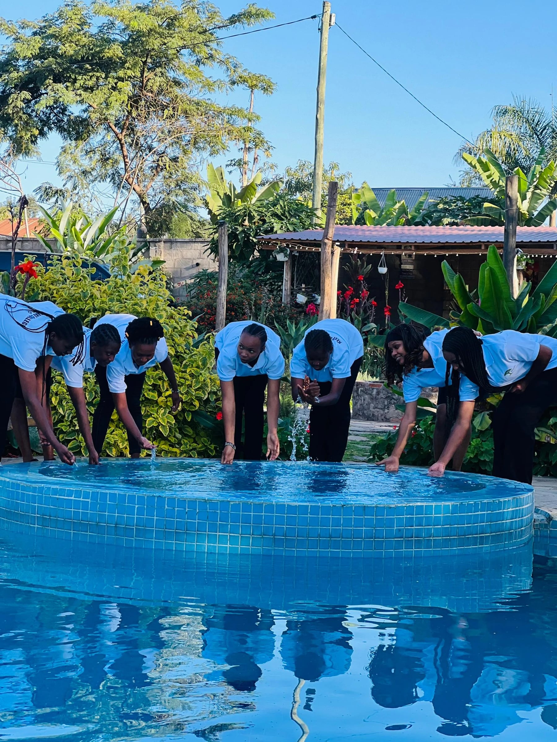 Keepsake students standing together beside a swimming pool